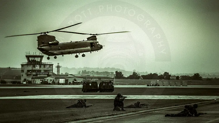 Chinook landing among soldiers and ATV