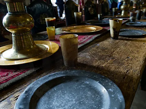 Close up of the brass and pewter tableware in the great hall